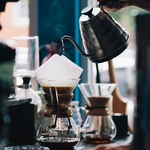 person filling glass container